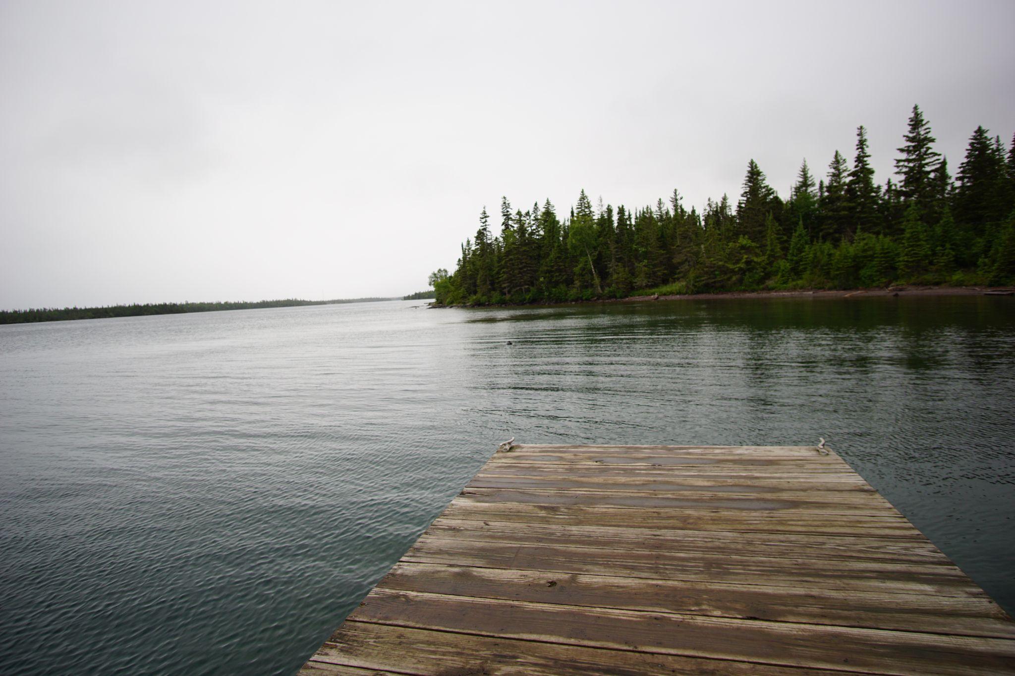 After some time, we took rest on the docks at one of the campgrounds, wood still wet from the rain. Deep blue mixing with the water’s grey.